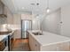 Bright, open kitchen with stainless steel appliances and large center island with pendant lighting at 4917 Lowell Blvd # 105, Denver, CO 80221
