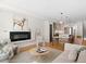 Bright, open living room features a fireplace, modern decor, and hardwood floors at 4917 Lowell Blvd # 105, Denver, CO 80221