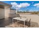 Outdoor rooftop patio features table, chairs, and views of blue sky and distant mountains at 4917 Lowell Blvd # 105, Denver, CO 80221
