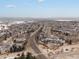 Aerial view of neighborhood featuring tree-lined streets and single-Gathering homes with mountain views at 6583 W Gould Dr, Littleton, CO 80123