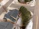 Aerial view of home featuring a dark roof, backyard deck, trees, street and surrounding landscape at 6583 W Gould Dr, Littleton, CO 80123