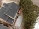 Aerial view of home featuring a dark roof, backyard deck, trees and surrounding landscape at 6583 W Gould Dr, Littleton, CO 80123