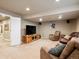 Finished basement with comfortable seating, carpeted floors, and tv at 6583 W Gould Dr, Littleton, CO 80123