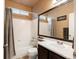 Bathroom featuring a large mirror, shower and bath with a single sink at 6583 W Gould Dr, Littleton, CO 80123