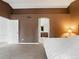 A bedroom with a neutral color palette and an attached bathroom visible through an arched doorway at 6583 W Gould Dr, Littleton, CO 80123