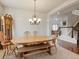 Elegant dining room featuring hardwood floors, stylish chandelier, and staircase at 6583 W Gould Dr, Littleton, CO 80123