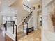 Grand entryway featuring an elegant staircase, tile flooring, and decorative accents creating a welcoming ambiance at 6583 W Gould Dr, Littleton, CO 80123