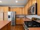 Bright kitchen showcasing stainless steel appliances and ample cabinet space with a kitchen island at 6583 W Gould Dr, Littleton, CO 80123