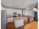 Bright kitchen with white cabinets, stainless steel appliances, center island and a view to the outside at 6583 W Gould Dr, Littleton, CO 80123