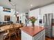 Open concept kitchen featuring island and view to the living room with fireplace and the stairway at 6583 W Gould Dr, Littleton, CO 80123