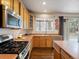 Another view of the kitchen, featuring a stainless steel sink and gas range at 6583 W Gould Dr, Littleton, CO 80123