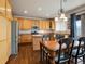 Well appointed kitchen featuring modern stainless steel appliances, wood cabinets, and an island at 6583 W Gould Dr, Littleton, CO 80123