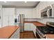 A well-lit kitchen with stainless steel appliances, white cabinets, and a center island at 6583 W Gould Dr, Littleton, CO 80123
