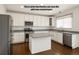 Bright kitchen featuring white cabinets, stainless steel appliances, and new grey countertops at 6583 W Gould Dr, Littleton, CO 80123