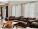 Inviting living room showcasing a comfortable leather sofa and a rustic wooden coffee table under natural light at 6583 W Gould Dr, Littleton, CO 80123