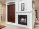 Cozy living room with a fireplace and custom wood built-ins at 6583 W Gould Dr, Littleton, CO 80123