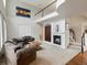 Living room with vaulted ceiling, fireplace, wooden floors and staircase at 6583 W Gould Dr, Littleton, CO 80123