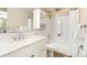 A bright bathroom with a white vanity, tile floors and walls, and a shower/tub combo at 655 S Clinton St # 2A, Denver, CO 80247