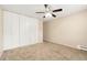 A bright bedroom is shown featuring a ceiling fan and a large closet for storage at 655 S Clinton St # 2A, Denver, CO 80247