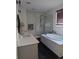 Modern bathroom features a soaking tub next to a glass-enclosed shower with a subway tile surround at 6332 E 142Nd Pl, Thornton, CO 80602