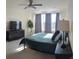 Comfortable bedroom with a large window, dark furniture, and gray accents at 6332 E 142Nd Pl, Thornton, CO 80602