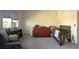Cozy Bedroom with hardwood crib, changing table dresser, grey chair, and natural light at 6332 E 142Nd Pl, Thornton, CO 80602