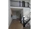 Spacious entryway with hardwood floors, white walls, and a dark staircase at 6332 E 142Nd Pl, Thornton, CO 80602
