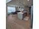 Open kitchen with an island, modern appliances, and an adjacent dining area at 6332 E 142Nd Pl, Thornton, CO 80602