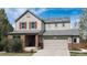 Charming two-story home featuring solar panels, a two-car garage, and a well-maintained front yard at 961 Stanley Ct, Erie, CO 80516
