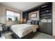 Bedroom with large window for natural light and built in shelves and cabinets for storage at 13452 Riley Peak Rd, Conifer, CO 80433