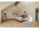 Comfortable bedroom with a plush bed, stylish decor, and a window providing natural light and views at 13452 Riley Peak Rd, Conifer, CO 80433