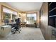 Bedroom with lots of natural light with large desk area and built in shelves and dressers for storage at 13452 Riley Peak Rd, Conifer, CO 80433