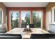 Close-up view of a dining area with a rustic wood table and bright window light at 13452 Riley Peak Rd, Conifer, CO 80433
