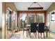 Dining room featuring many windows with mountain views and a modern light fixture at 13452 Riley Peak Rd, Conifer, CO 80433