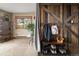 Inviting entryway featuring a unique barn door, storage bench, and ample space at 13452 Riley Peak Rd, Conifer, CO 80433