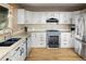 Well-lit kitchen featuring stainless steel appliances, granite countertops, and wood floors, with ample counter space at 13452 Riley Peak Rd, Conifer, CO 80433