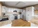 A sunlit kitchen with stainless steel appliances, granite countertops, and white cabinets, blending style with functionality at 13452 Riley Peak Rd, Conifer, CO 80433