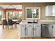 Bright kitchen with stainless appliances, granite countertops, and a view into the dining area, perfect for entertaining at 13452 Riley Peak Rd, Conifer, CO 80433
