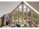 Bright living room with stone fireplace, high ceilings, large windows, and stunning mountain views at 13452 Riley Peak Rd, Conifer, CO 80433