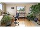 Inviting home office with wood floors, plants, and natural light, creating a productive workspace at 13452 Riley Peak Rd, Conifer, CO 80433