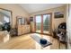 Bright yoga room with hardwood floors, natural light, and sliding doors leading to an outdoor space at 13452 Riley Peak Rd, Conifer, CO 80433