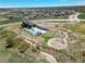 An aerial view of the community clubhouse, pool, playground, and surrounding homes at 3293 Offbeaten Pl, Castle Rock, CO 80108