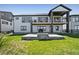 Spacious backyard with grass and stone patio with firepit at 3293 Offbeaten Pl, Castle Rock, CO 80108