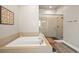 Relaxing bathroom features a soaking tub and a walk-in shower with glass door at 3293 Offbeaten Pl, Castle Rock, CO 80108
