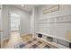 Welcoming entryway with custom storage, bench, and charming decor at 3293 Offbeaten Pl, Castle Rock, CO 80108