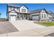Stunning two-story home with a three-car garage and welcoming front porch at 3293 Offbeaten Pl, Castle Rock, CO 80108