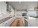Bright kitchen featuring stainless steel appliances, ample white cabinetry and large island with seating at 3293 Offbeaten Pl, Castle Rock, CO 80108