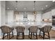 Modern kitchen with a large island, pendant lighting, and stylish bar stools at 3293 Offbeaten Pl, Castle Rock, CO 80108