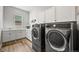 Laundry room with front loading washer and dryer, storage cabinets, and a utility sink at 3293 Offbeaten Pl, Castle Rock, CO 80108