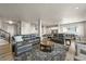 Open-concept living room with a modern design, a cozy seating area, and access to kitchen at 3293 Offbeaten Pl, Castle Rock, CO 80108